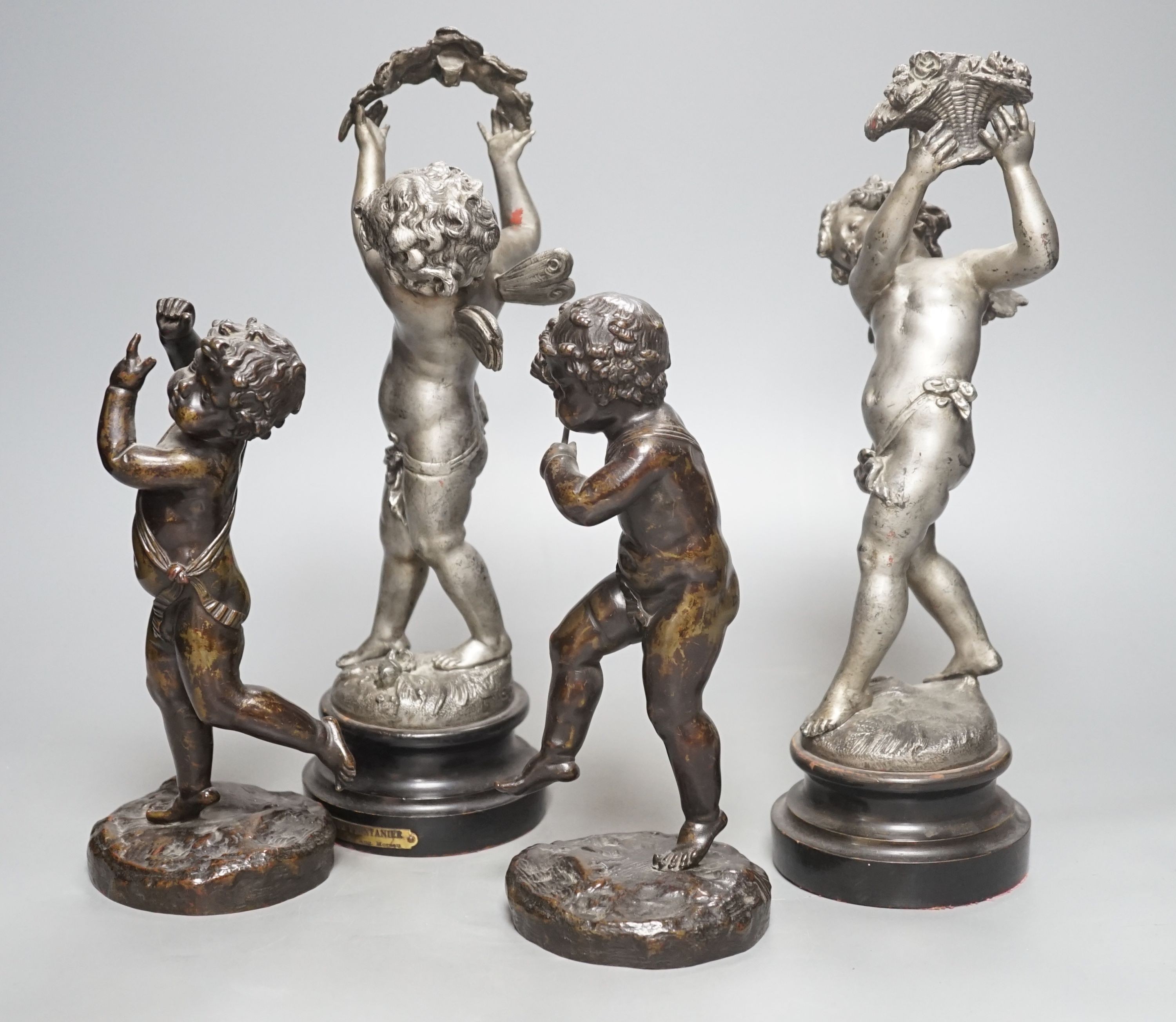 A pair of bronze musical putti and a pair of seasonal spelter putti - tallest 32cm